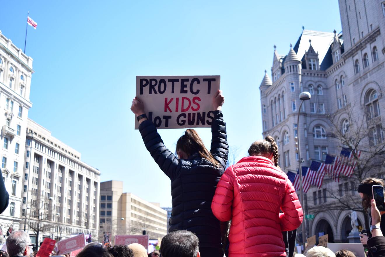 Two girls hold a sign at a March for Our Lives rally in Washington D.C.